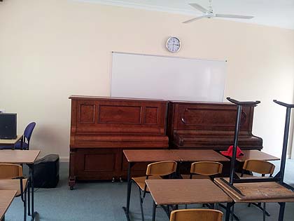 image moving a pianos in school